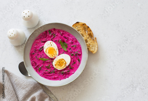 Cold beetroot cucumber egg soup in a bowl close up