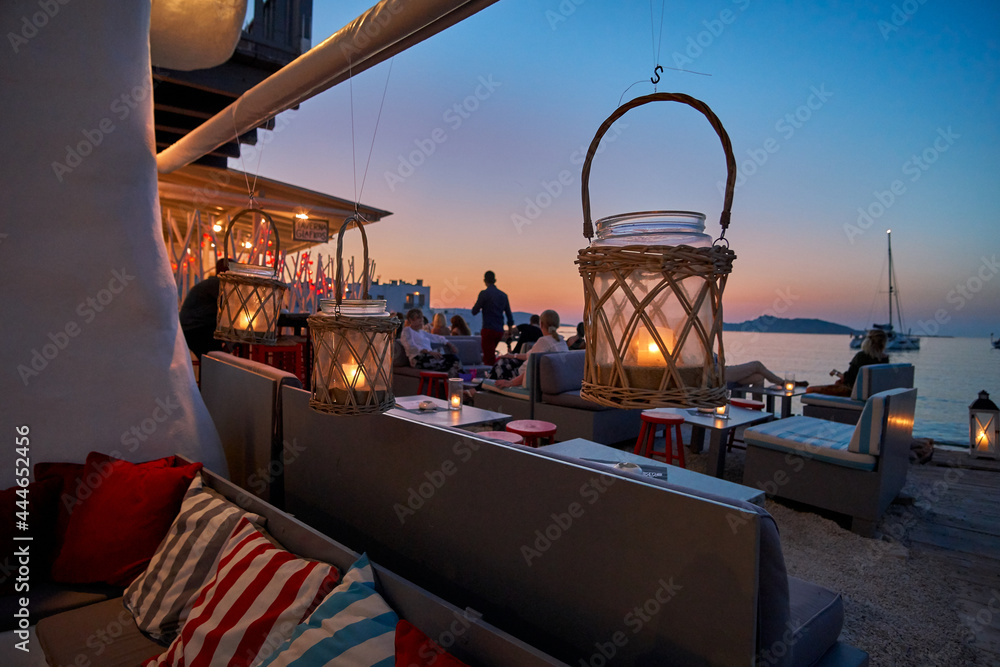 Fototapeta premium PAROS, CYCLADES, GREECE - JUNE 2017: Night view while walking in the picturesque seaside village of Naousa in the island of Paros, Cyclades, Greece, during summer period