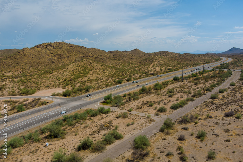 Aerial view highway across the arid desert Arizona mountains adventure traveling desert road Aerial view highway across the arid desert Arizona mountains adventure traveling desert road