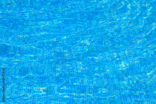 Texture of water in swimming pool for background. Surface of blue swimming pool