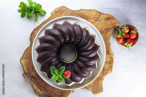 Brownies Kukus Keju or Steamed cheese bundt cake, an Indonesian rendition of the famous American brownies, on white plate. photo