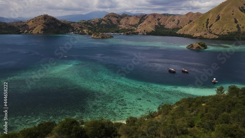 Beautiful Scenery Of The Coastal Hills Near Menjaga Village At Komodo, East Indonesia From Th Viewpoint Of Kelor Island. aerial photo