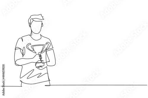 Single one line drawing male athlete wearing sports jersey holding golden trophy with both hands. Celebrating victory of national competition. Continuous line draw design graphic vector illustration