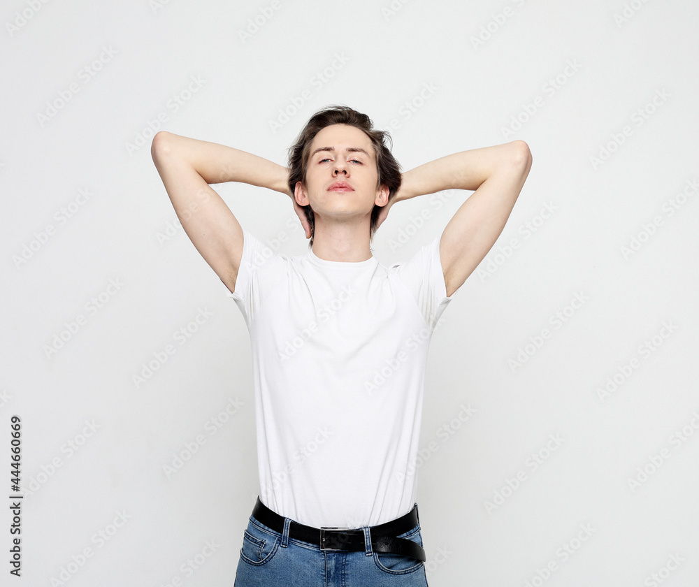 Photo of young man happy positive smile rest relax break hands behind head Photo of young man happy positive smile rest relax break hands behind head