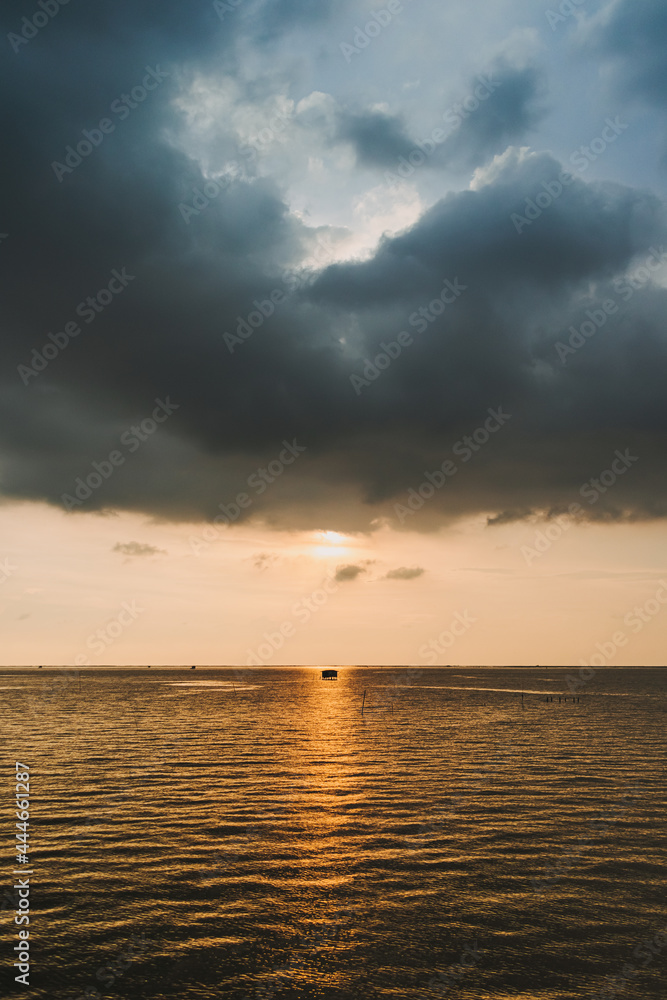 Tiny fishing hut in the middle of sunset and the sea. Tiny fishing hut in the middle of sunset and the sea.