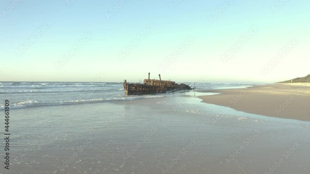 Drone approaching the old shipwreck, SS Maheno, on a beautiful beach of Fraser Island, Australia. Drone approaching the old shipwreck, SS Maheno, on a beautiful beach of Fraser Island, Australia.