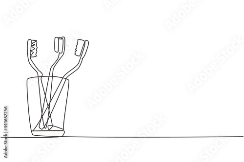 Single continuous line drawing several toothbrushes in glass. Dental care equipment at home. Brushing teeth. Teeth care concept. Oral care center. One line draw graphic design vector illustration