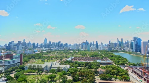 Queen Sirikit National Convention Centre construction site near Benjakitti Park and Lake, Millenium Residence Apartment, CTI Tower, Ocean Tower in Bangkok, Thailand on Sunny day time-lapse photo