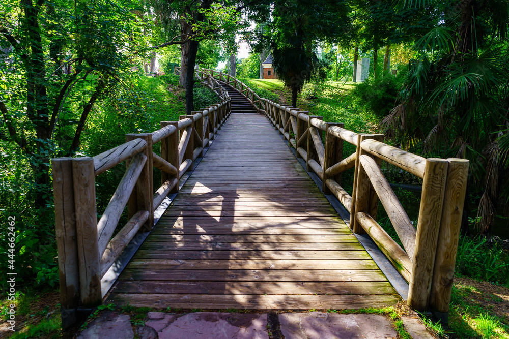 Wooden bridge over a small stream in the Retiro public park, Madrid. Wooden bridge over a small stream in the Retiro public park, Madrid.