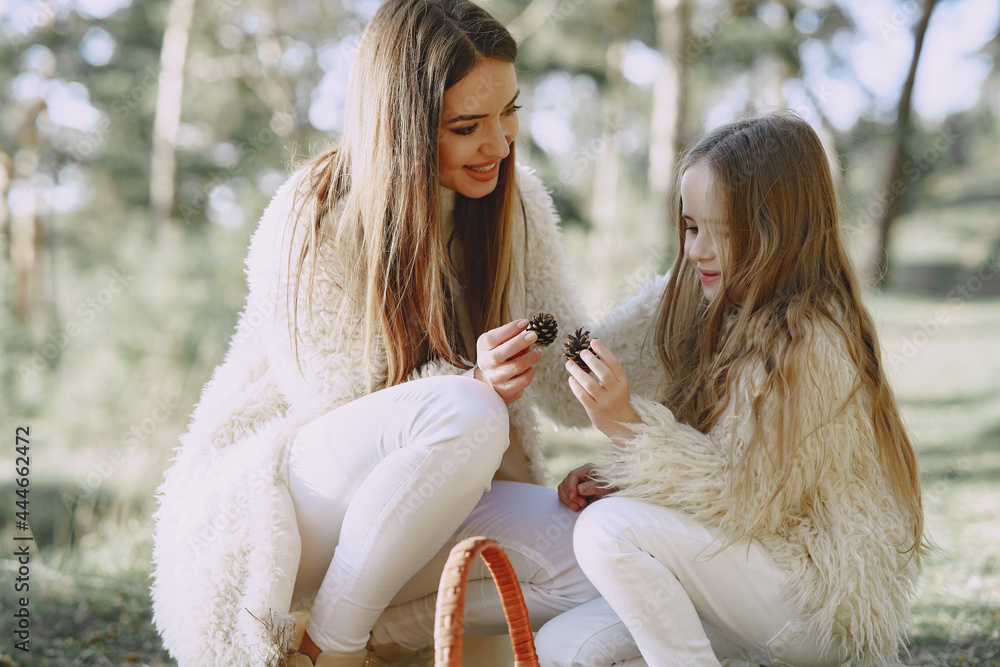 Elegant mother with daughter in a summer forest Elegant mother with daughter in a summer forest
