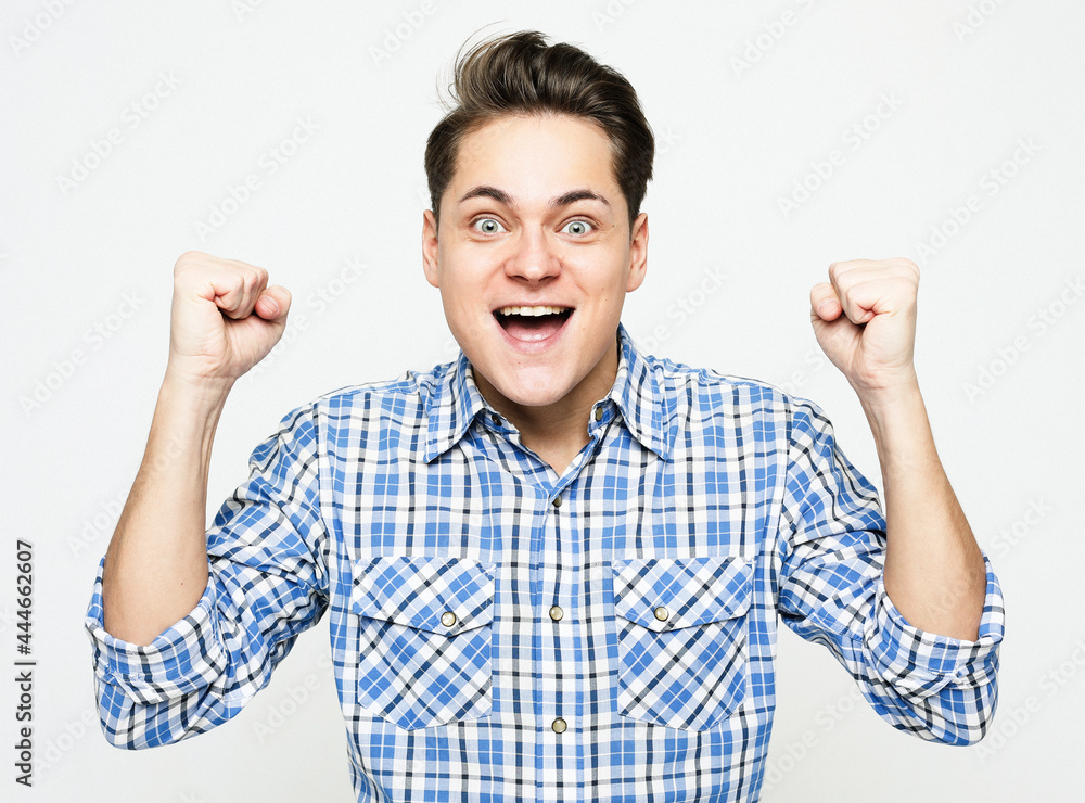 Portrait of triumphing handsome adult man chanting, celebrating success or achievement Portrait of triumphing handsome adult man chanting, celebrating success or achievement