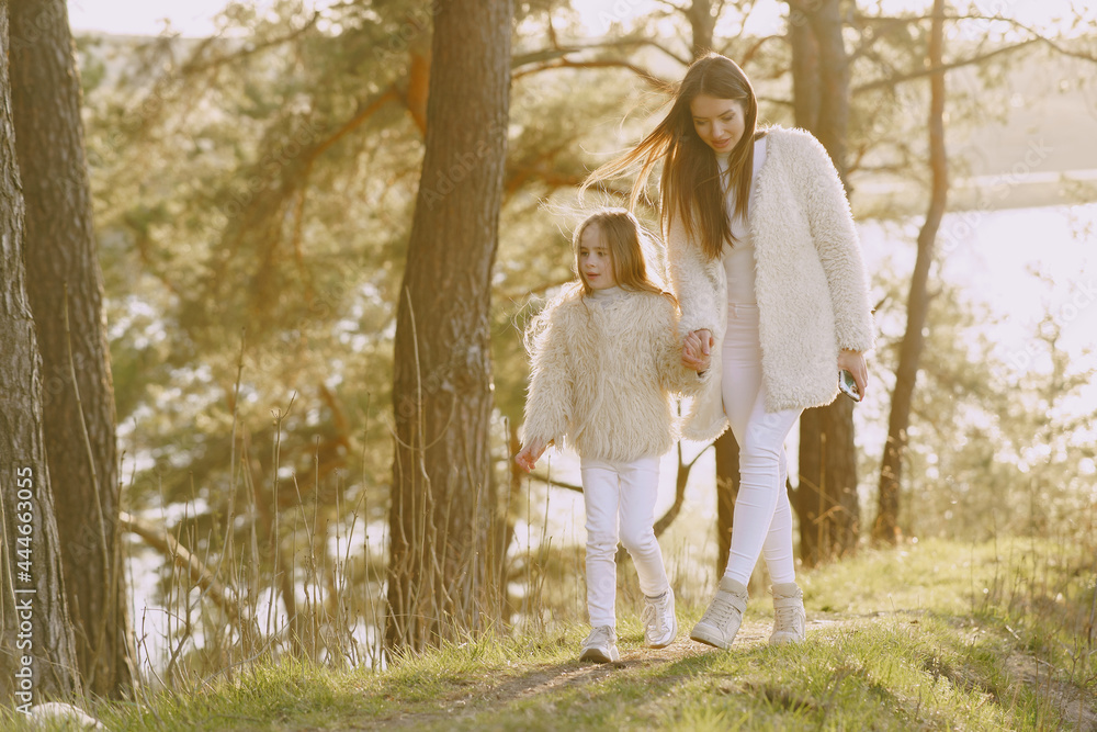 Elegant mother with daughter in a summer forest Elegant mother with daughter in a summer forest