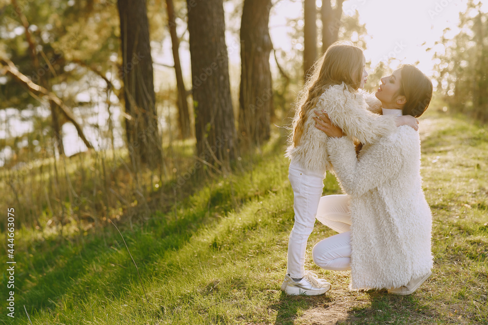 Elegant mother with daughter in a summer forest Elegant mother with daughter in a summer forest