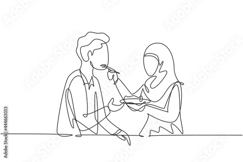 Continuous one line drawing romantic Arabian woman feeds her husband. Happy couple dinner together at restaurant. Celebrate wedding anniversaries. Single line draw design vector graphic illustration