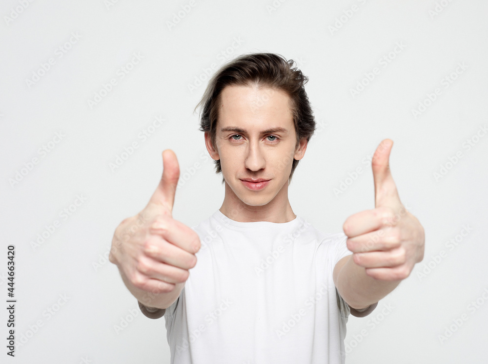 Pleased good-looking happy male showing thumbs up Pleased good-looking happy male showing thumbs up