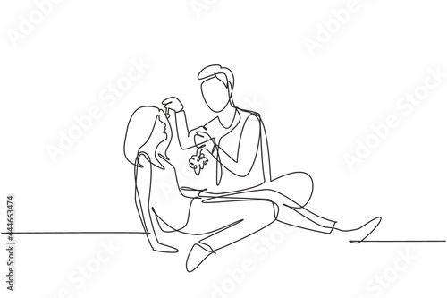 Continuous one line drawing romantic couple having picnic in summer park. Relaxing together sitting on the ground and men feeding grapes to women. Single line draw design vector graphic illustration