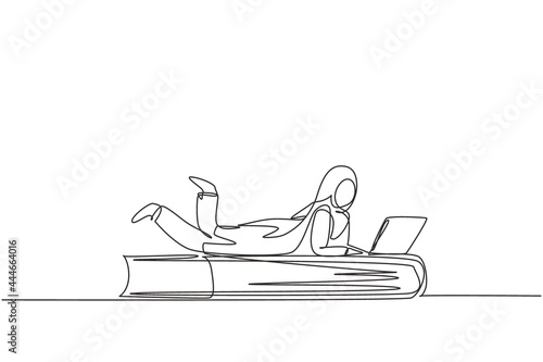 Continuous one line drawing young Arab female with laptop laying down on big book. Freelance, distance learning, online courses, studying concept. Single line draw design vector graphic illustration