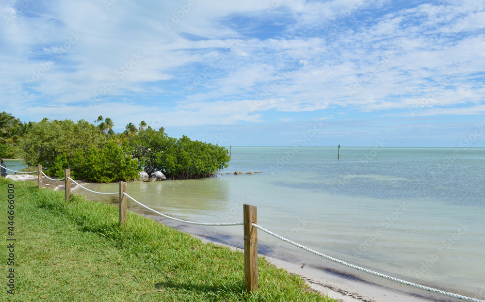 Wood beach fence along Key West beach picnic area in Florida, USA