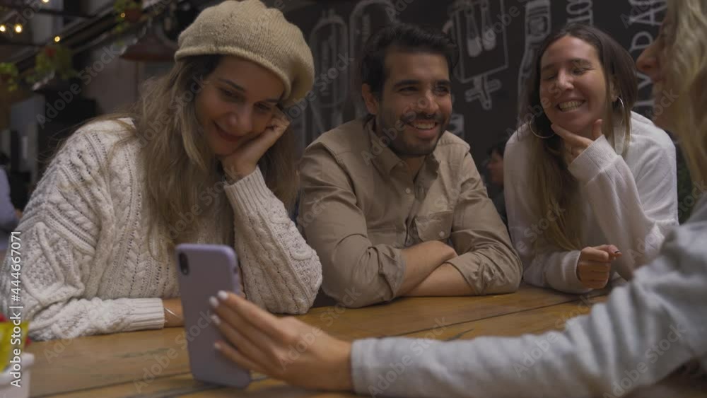 Group facetime a distant lost friend with buddies at the bar Group facetime a distant lost friend with buddies at the bar