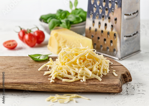 grated cheese on wooden cutting board photo