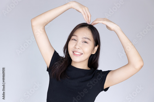woman with heart gesture, concept of heart disease awareness, heart care, heart attack awareness day or month © 9nong