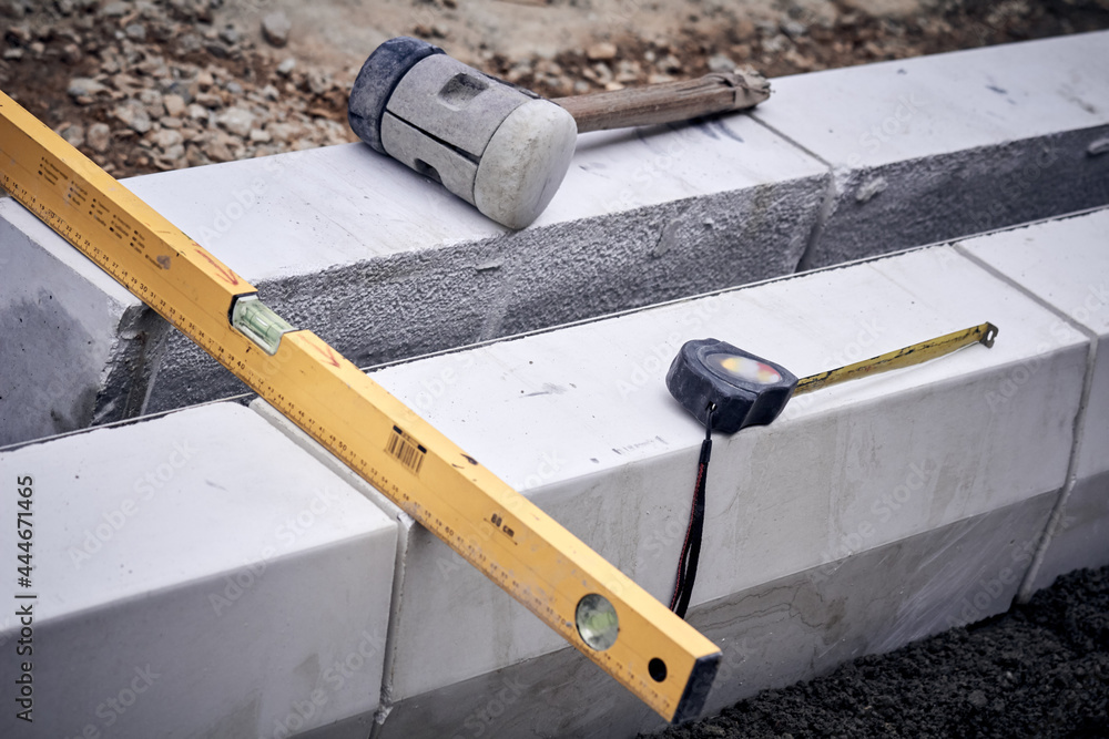Spirit level and tools on a contruction site.