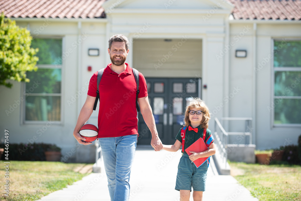 School boy going to school with father.