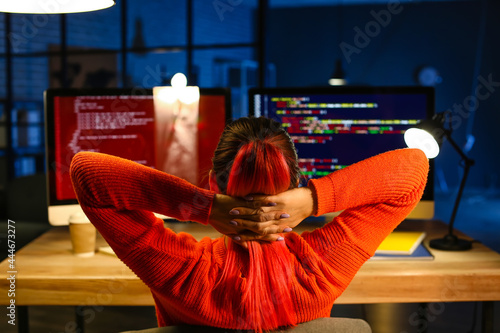 Female programmer relaxing in office at night