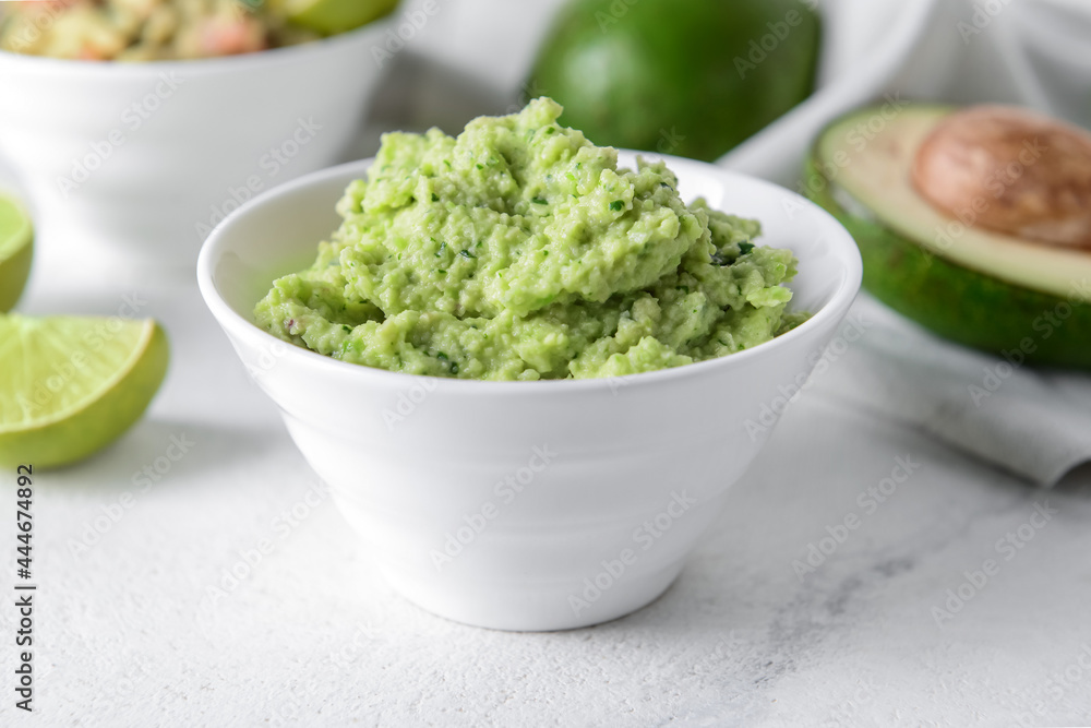 Bowl with tasty guacamole on table, closeup Bowl with tasty guacamole on table, closeup