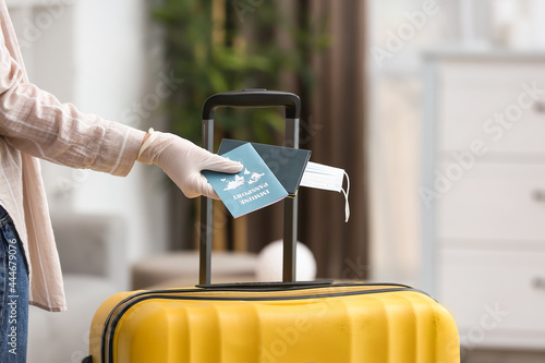 Woman with packed suitcase,...