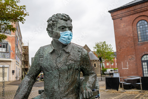 Dylan Thomas statue wearing a Covid face mask, Swansea, Wales, UK. Coronavirus in Wales concept #444680810