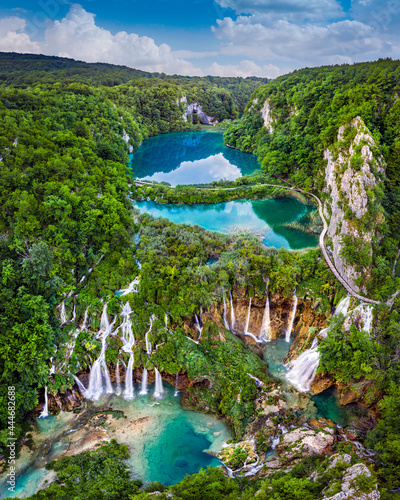 Fototapeta Naklejka Na Ścianę i Meble -  Plitvice, Croatia - Amazing view of the beautiful waterfalls of Plitvice Lakes in Plitvice National Park on a bright summer day with blue sky and clouds and green foliage and turquoise water