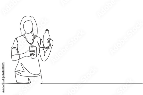 Continuous one line drawing young beautiful woman holding bottle in one hand and glass of orange juice in the other while having breakfast at home. Single line draw design vector graphic illustration