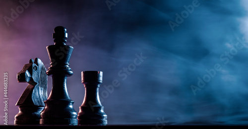 Chess pieces on a dark background photo