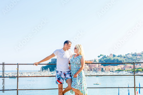 a woman and a man are leaning on a classic railing on the embankment © Angelov