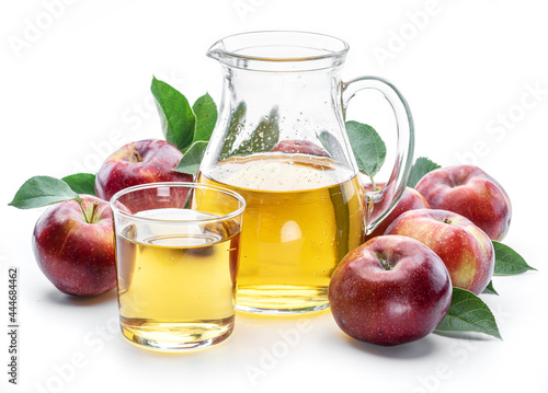 Glass and carafe of fresh apple juice and organic apples isolated on white background.