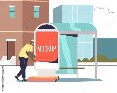 Male advertising agency worker putting promotion poster mockup on bus station