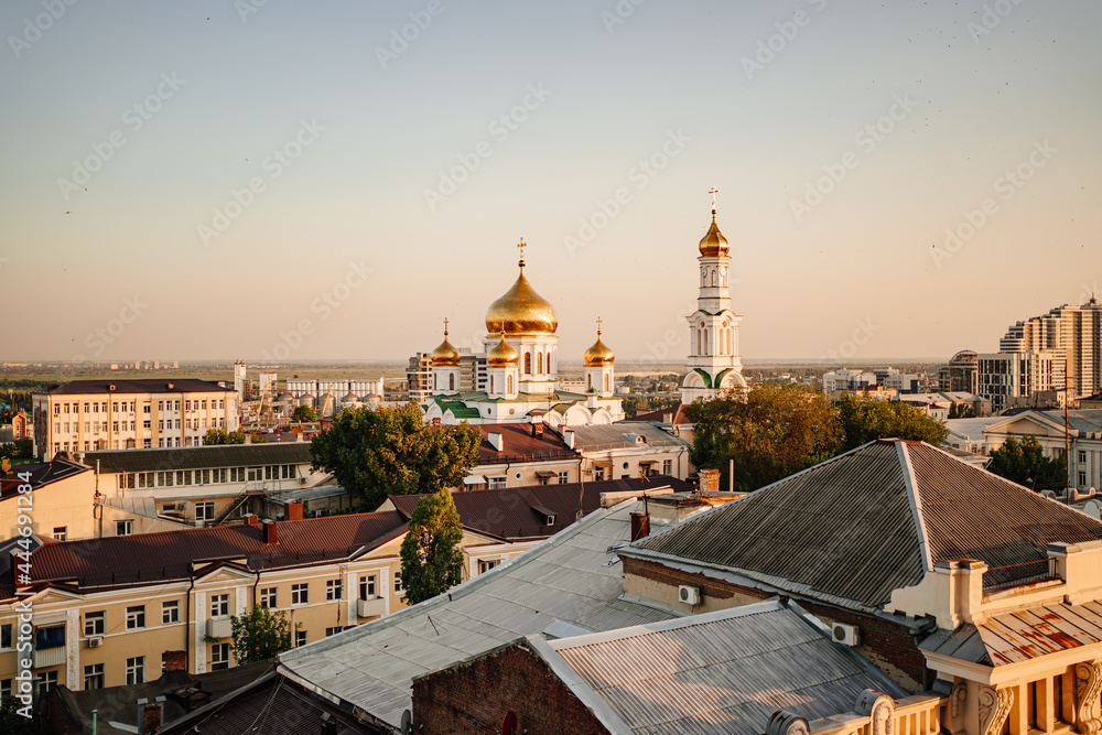 view from the rooftop to the evening city and the Orthodox Church. 