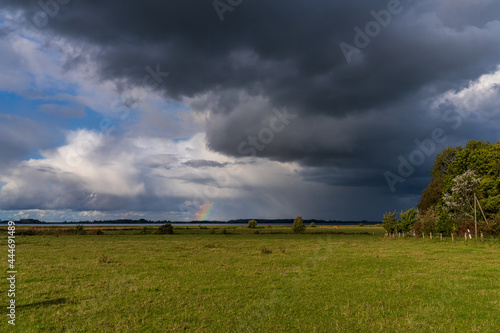 Fototapeta Rainclouds and a rainbow near Boeschow, Mecklenburg-Western Pomerania, Germany