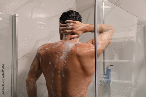 Photos Man taking shower with gel at home