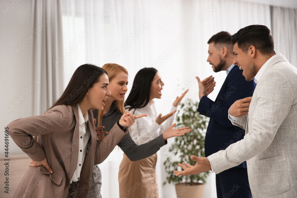 Group of angry coworkers quarreling in office Group of angry coworkers quarreling in office