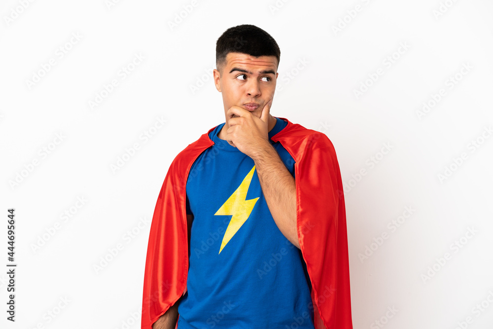 Super Hero over isolated white background having doubts and with confuse face expression Super Hero over isolated white background having doubts and with confuse face expression