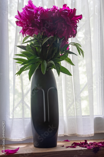 Vase with flowers and fallen leaves