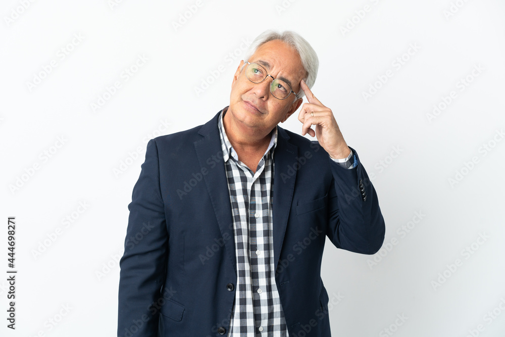 Middle age Brazilian man isolated on white background making the gesture of madness putting finger on the head Middle age Brazilian man isolated on white background making the gesture of madness putting finger on the head