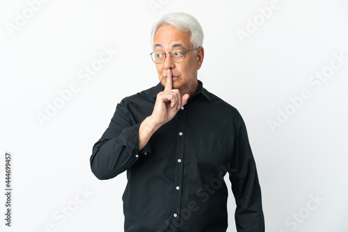 Middle age Brazilian man isolated on white background showing a sign of silence gesture putting finger in mouth