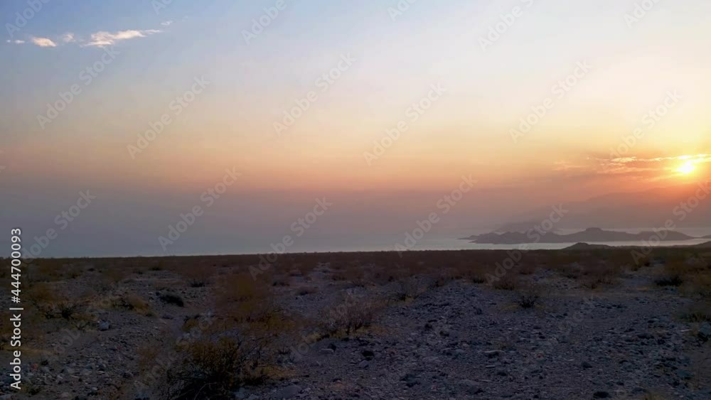 Dawn Breaking at Lake Mead shoreline with sunrise over water Dawn Breaking at Lake Mead shoreline with sunrise over water