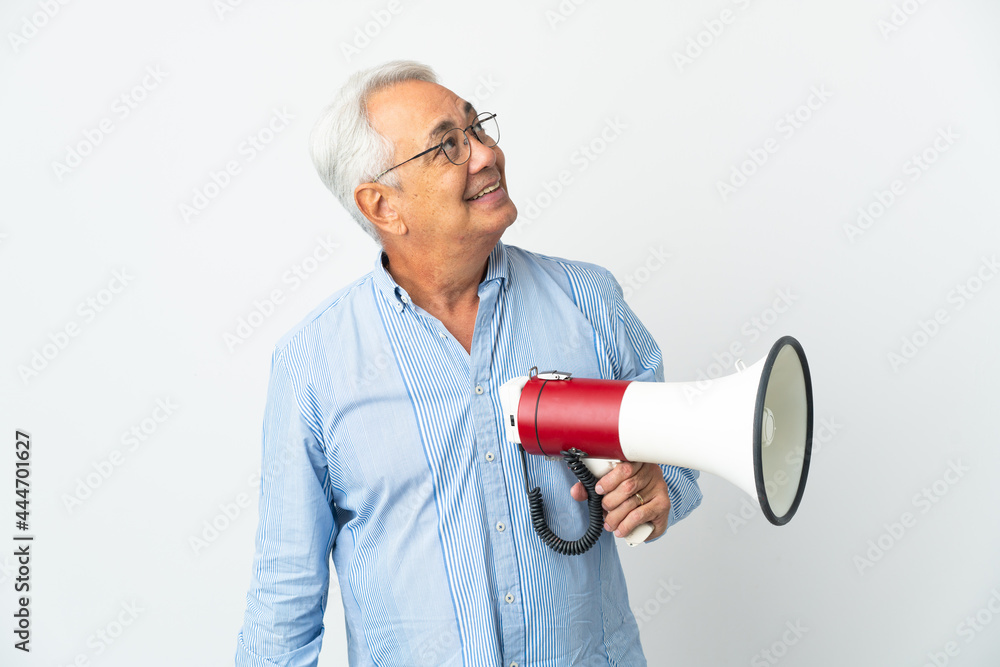 Middle age Brazilian man isolated on white background holding a megaphone and looking up while smiling Middle age Brazilian man isolated on white background holding a megaphone and looking up while smiling