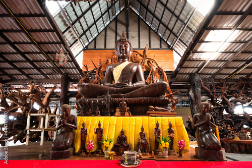 Chachoengsao, Thailand, April 22, 2021: Wat Pa Khao Lom, Peaceful place and Buddha statue carved with Takhian tree. photo