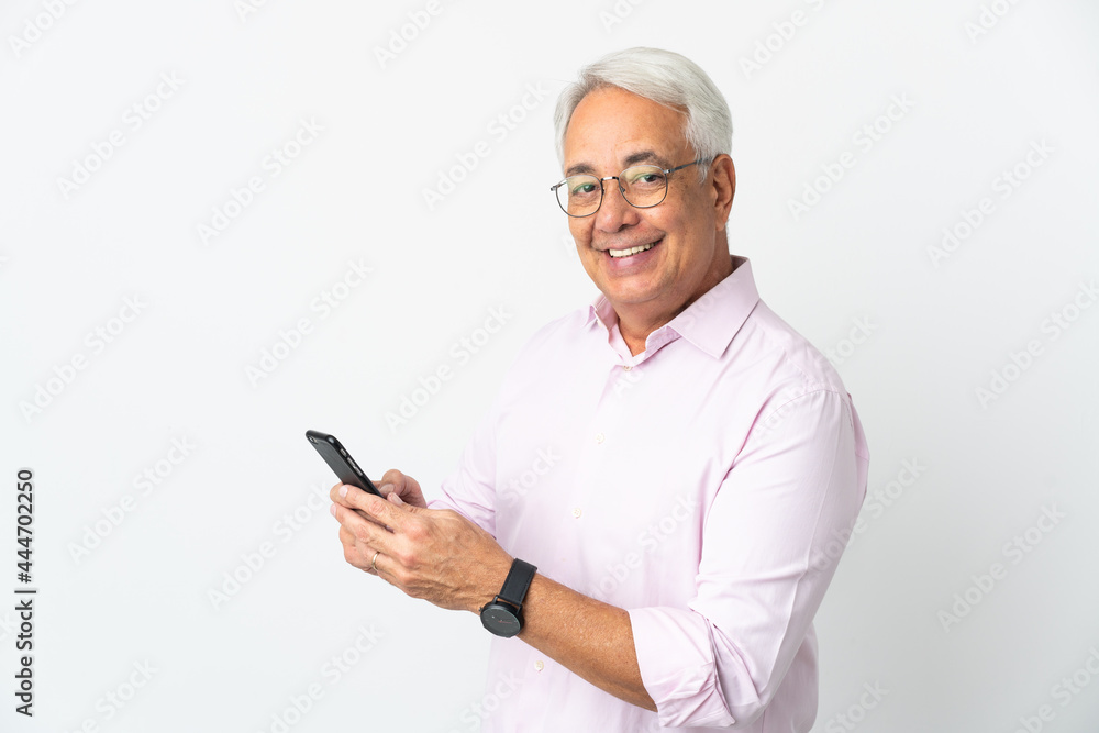 Middle age Brazilian man isolated on white background sending a message or email with the mobile Middle age Brazilian man isolated on white background sending a message or email with the mobile