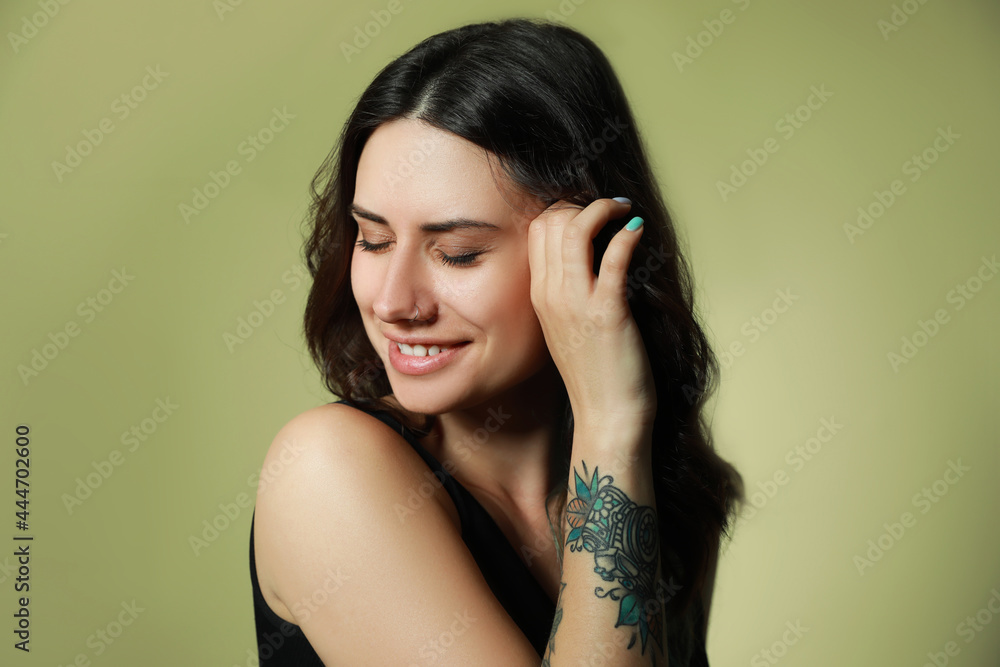 Beautiful young woman with nose piercing on green background Beautiful young woman with nose piercing on green background